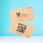 Digital business card with a wood-like texture and the label "VCARD Tap, Share, Connect," featuring a QR code and the NFC symbol.